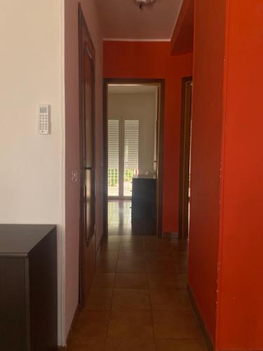 an empty hallway with orange walls and a door at San Lorenzo beach in Marina di San Lorenzo