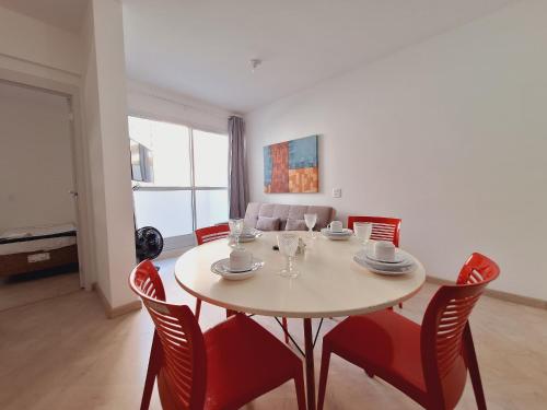 a dining room with a table and red chairs at LK Centro 2 in Belo Horizonte