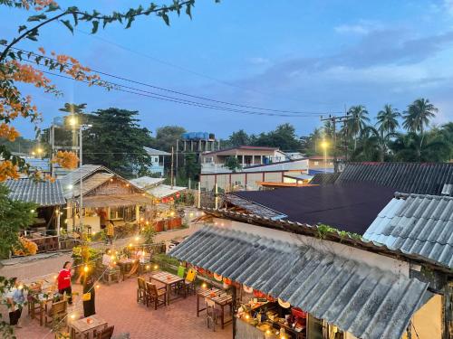 an overhead view of a street with tables and buildings at MOOK BOONCHU HOTEL in Koh Mook