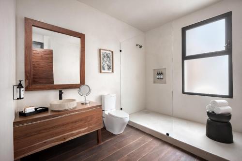a bathroom with a toilet and a sink and a mirror at Secrets Tulum Resort & Beach Club - Adults Only - All Inclusive in Tulum