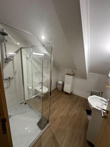 a bathroom with a glass shower and a sink at Castle House Loulé City Center in Loulé