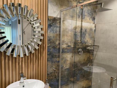 a bathroom with a sink and a mirror at Bel-Air Guesthouse in Klerksdorp
