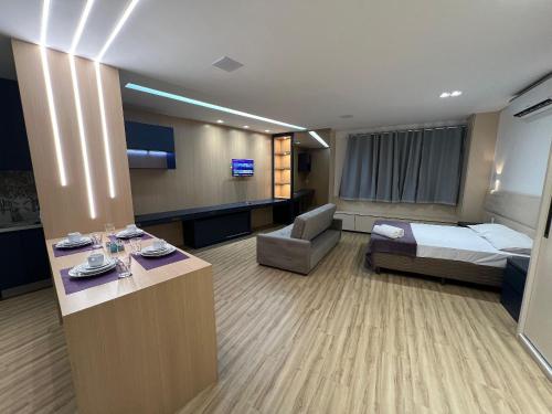 a hotel room with a bed and a couch at LK Santo Agostinho 6 in Belo Horizonte