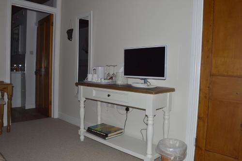 a computer monitor on a desk in a room at Troedyrhiw Bed & Breakfast in Cardigan