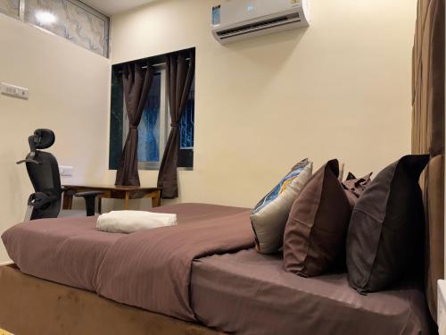 a bedroom with a large bed and a desk at OSI Apartments Kurla West in Mumbai