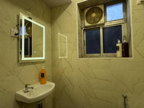 a bathroom with a sink and a window at OSI Apartments Kurla West in Mumbai