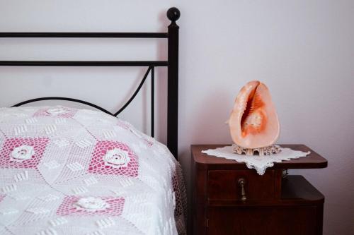 a bedroom with a bed with a mouth on a night stand at Tsikalario Holiday House in Tsikkalarión