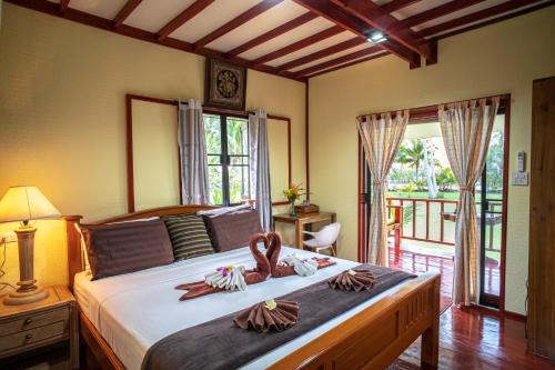 Ένα ή περισσότερα κρεβάτια σε δωμάτιο στο SiBoya Bungalows