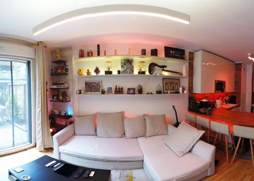 un salon avec un canapé blanc et une table dans l'établissement NEW LUX Smart Home 69m2,Terrasse, Modern, Metro 13, à Asnières-sur-Seine