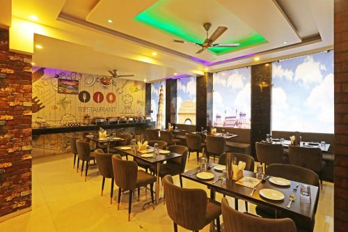 un ristorante con tavoli e sedie in una stanza di Smart Lax Hotel By SMART GROUP a Nuova Delhi
