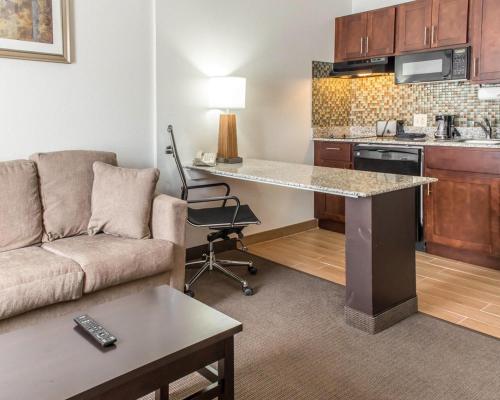 a living room with a couch and a table in a kitchen at MainStay Suites Pittsburgh Airport in Imperial