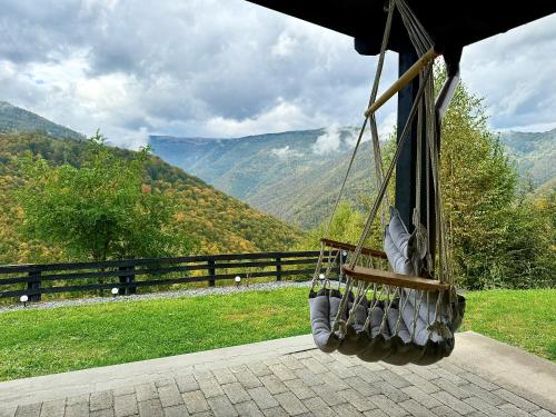 a hanging hammock with a view of a mountain at Refugiul Panoramic in Muntele Rece