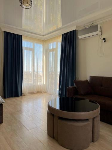 a living room with a couch and a table at GT House Batumi in Batumi