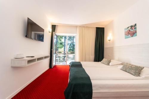Postel nebo postele na pokoji v ubytování Hotel Cirus