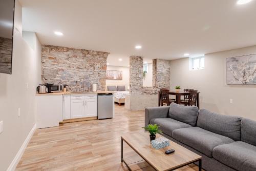 a living room with a couch and a kitchen at ENTIRE 1 BEDROOM APARTMENT ACROSS FROM GOOGLE - br1 in Kitchener