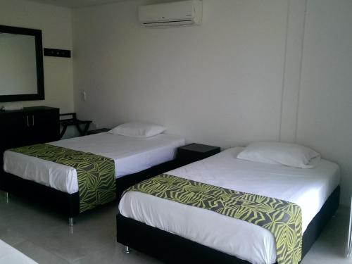 Tempat tidur dalam kamar di Hotel Septima Avenida