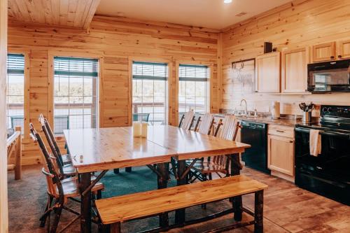 a kitchen with a wooden table and chairs at Keweenaw Waters Resort in Houghton