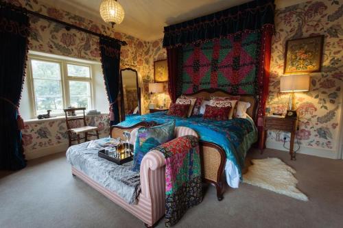 a bedroom with a bed and a couch in it at Moscar Lodge, Peak District in Ughill