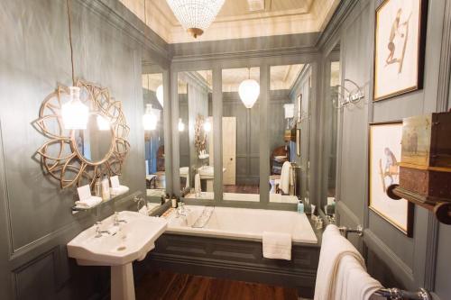 a bathroom with a tub and a sink and a mirror at Moscar Lodge, Peak District in Ughill
