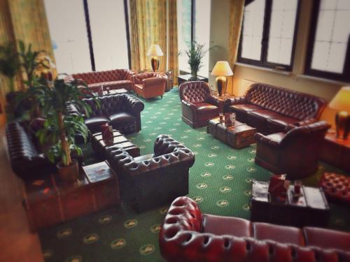 a living room with couches and chairs in a building at Alpina Lodge Hotel Oberwiesenthal in Kurort Oberwiesenthal
