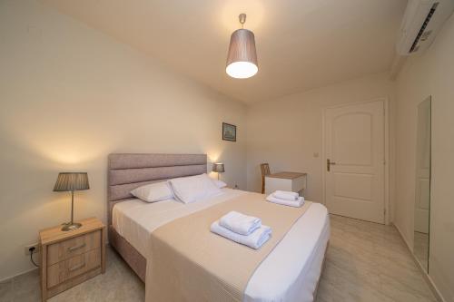 a bedroom with a bed with two towels on it at Sandoa Residence - Lualaba & Tenke in Minia