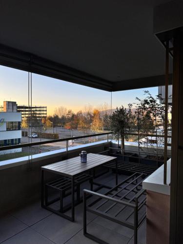 a table and chairs on a balcony with a view at Römer Apartment in Kaiseraugst