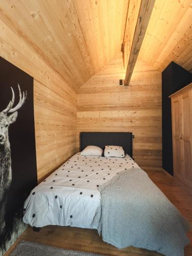 une chambre avec un lit dans une cabane en bois dans l'établissement Mazot du Criou - Samoëns, à Samoëns
