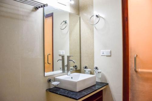 a bathroom with a sink and a mirror at Laguna Retreat in Vaadhoo