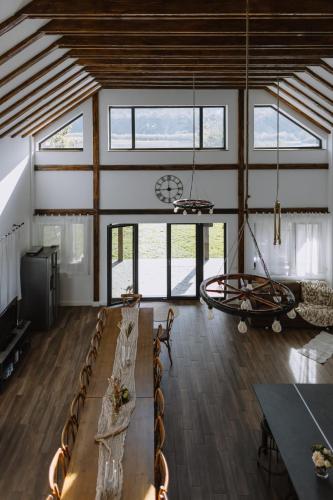 a living room with a table and chairs and a clock at Chalet Odette in Pangarati