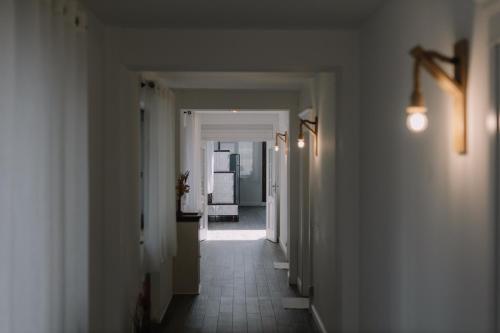 a hallway with white walls and a hallway with at Chalet Odette in Pangarati