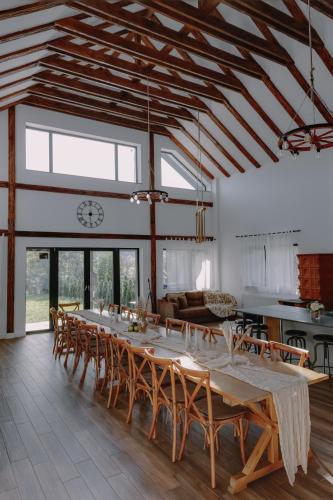 a large dining room with a long table and chairs at Chalet Odette in Pangarati