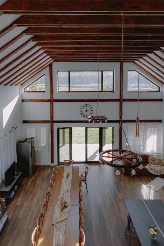 a room with chairs and a table and a clock at Chalet Odette in Pangarati