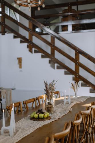 a long table with chairs and candles on it at Chalet Odette in Pangarati