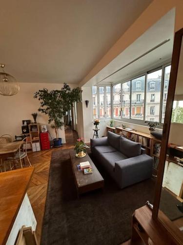 un salon avec un canapé et une table dans l'établissement Grand loft Montmartre, à Paris