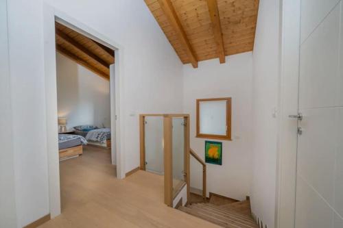 a room with white walls and a wooden ceiling at Sun Villa in Càneva