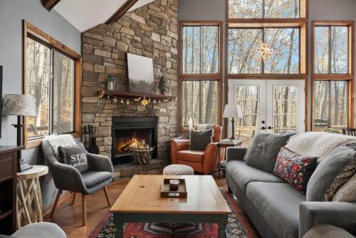 a living room with a couch and a fireplace at Mountainside w Fireplace, Fire Pit, Deck, & WiFi in Smith Crossroads