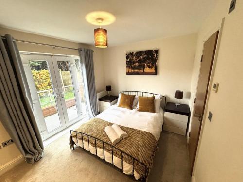 a bedroom with a bed and a large window at Spacious 2-Bedroom Apartment with Parking in Windsor 4LA by Accommodation Windsor in Windsor