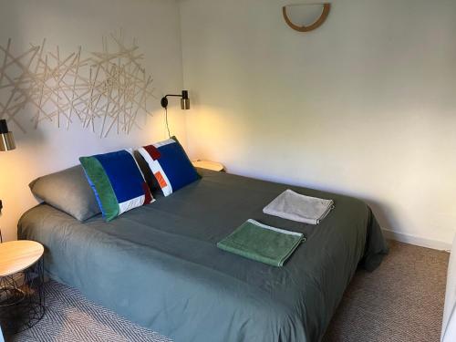 un lit avec des oreillers dessus dans une chambre dans l'établissement Le Merle Rose, à Toulouse