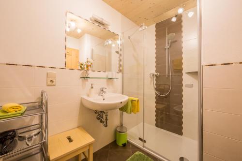 a bathroom with a sink and a shower at Obermarhof Gsies in Prateria