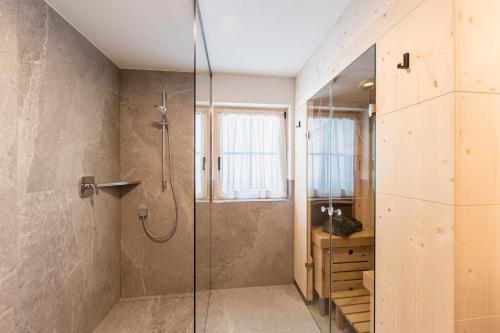 a bathroom with a shower with a glass door at Obermarhof Gsies in Prateria