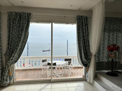 a room with a balcony with a view of the ocean at Riad Ras Lafaa in Safi