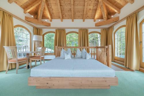 a bedroom with a bed and a table and chairs at KERSCHDORFER - wohlfühlhotel garni - adults only in Kaltenbach