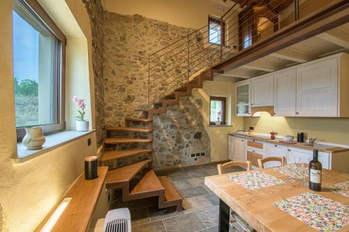 a kitchen with a wooden staircase in a house at Fontanassa ss in Gavi