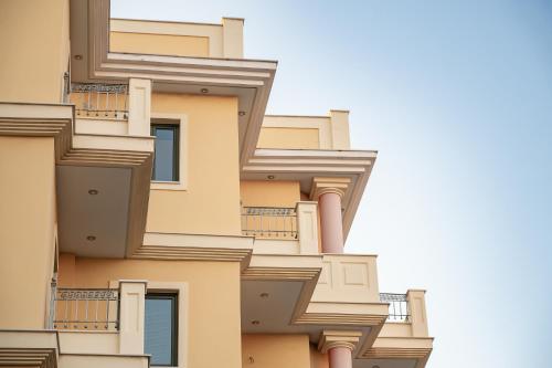 a facade of a building with balconies at eleVSis 1 in Elefsina