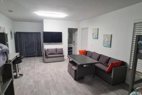 a living room with a couch and a table at Sea View in Melbourne Beach