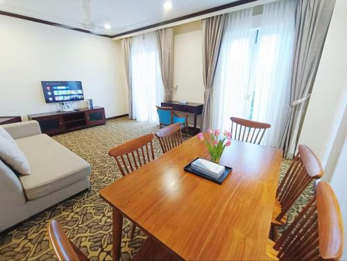 a living room with a wooden table and a couch at Riviera Melaka Private Suites by Jeffery Lam Home Management in Malacca