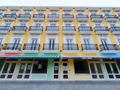 a yellow building with balconies on the side of it at Riviera Melaka Private Suites by Jeffery Lam Home Management in Malacca