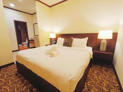 a hotel room with a large bed with two lamps at Riviera Melaka Private Suites by Jeffery Lam Home Management in Malacca