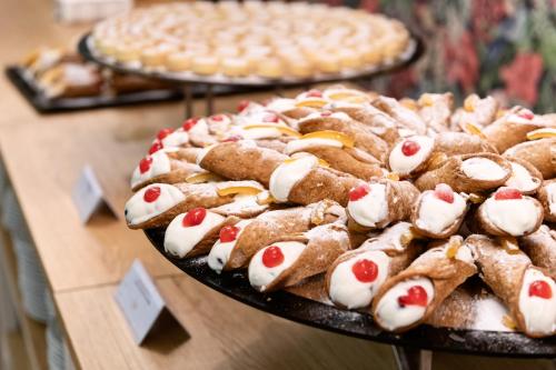 a display of cookies and a pie on a table at VOI Arenella Resort in Arenella