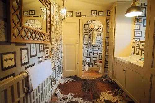 a bathroom with a sink and a hallway with a mirror at 5 bedroom Manor with idyllic countryside views in Croxton Kerrial